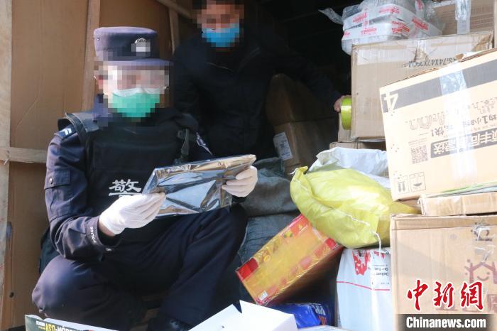 圖為勐康邊檢站民警在對快遞運輸車輛進行例行檢查。　楊添 攝